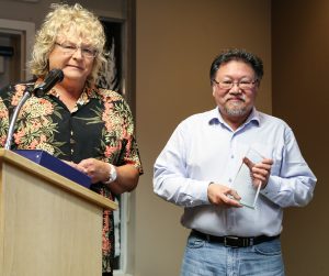 David Lee receives his Award of Excellence for organizing the speaker series for the DAO Summer Star Parties from Sherry Buttnor