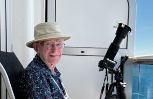 John McDonald photographing and obseving the 2024 Total Solar Eclipse from a balcony aboard the Discovery Princess