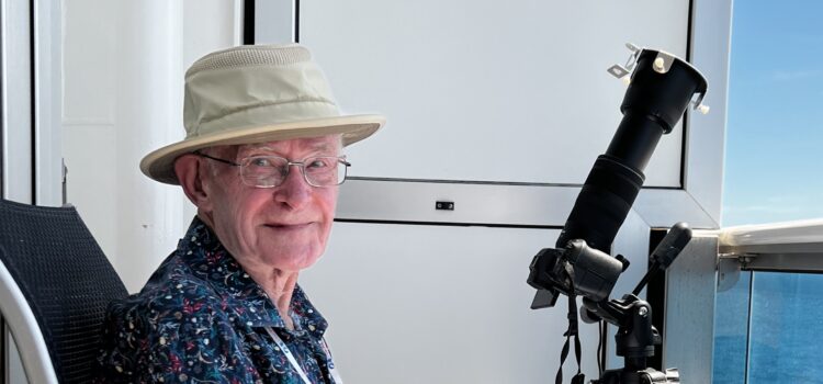 John McDonald photographing and obseving the 2024 Total Solar Eclipse from a balcony aboard the Discovery Princess