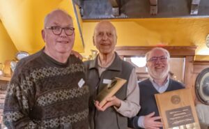 Sid Sidhu receiving the Newton-Ball Service award in 2025 from Chris Gainor and Randy Enkin