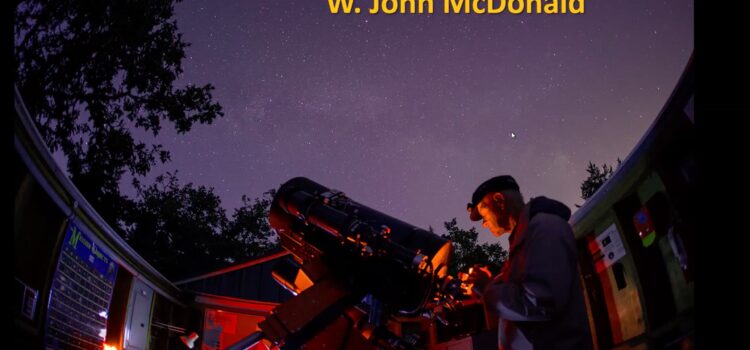 John McDonald - self-portrait observing from the Victoria Centre Observatory with red lights and a dark sky above
