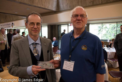 Bill Almond – 1933-2022 – In Memorium Bill Almond presents a copy of his Victoria Centre history to RASC Archivist Randall Rosenfeld